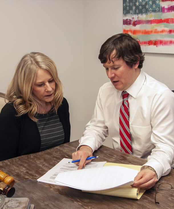 An image of Attorney Austin Buerlein consulting with a client in the EO family law office. 